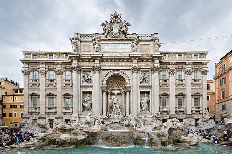 A decorated marble fountain with several roman statues dancing.