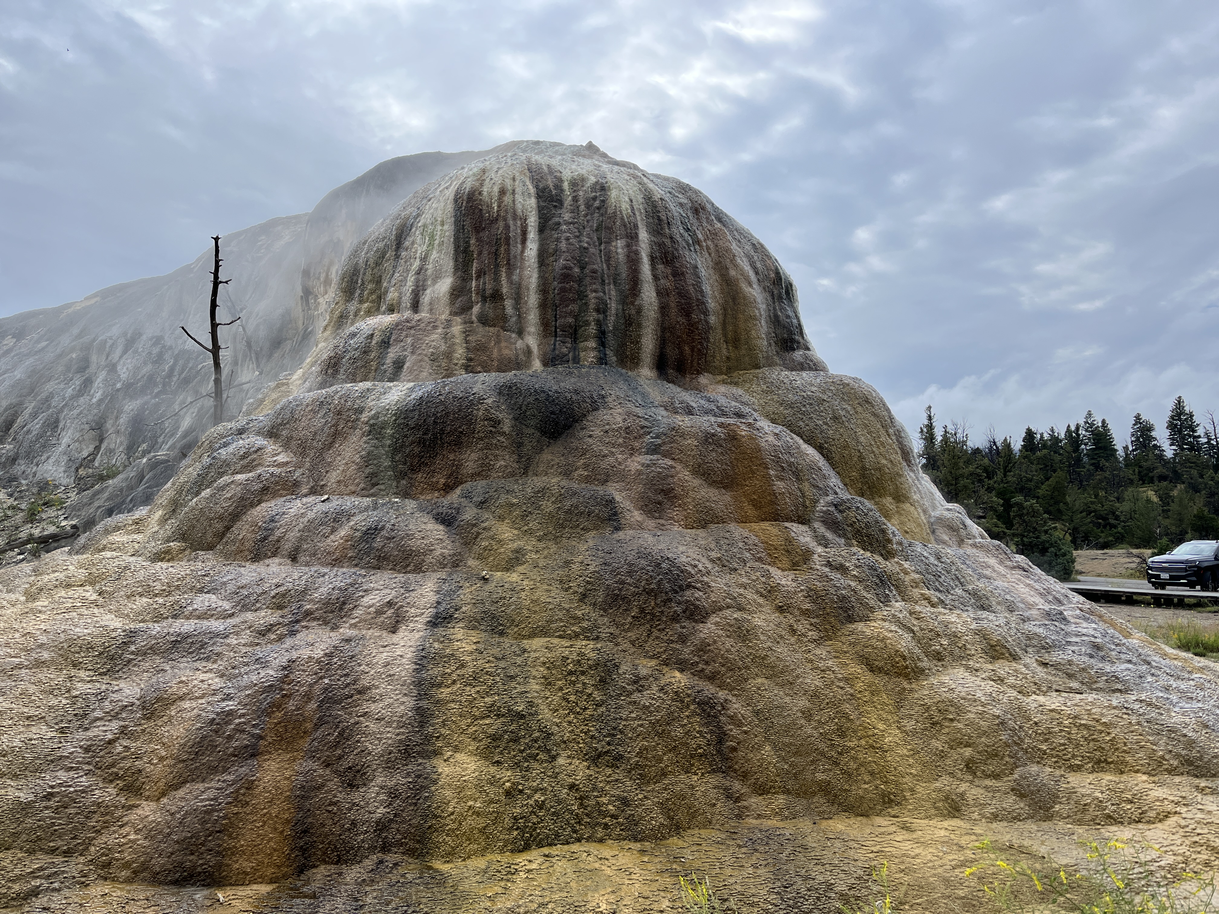 A large mound of multi-colored travertine